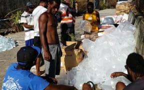 Volunteers - including RNZI's Koroi Hawkins - help fill water ahead of an aid mission to Vanuatu's Shepherd Islands.
