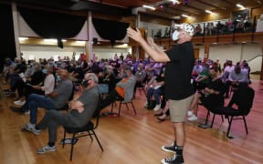 Whangārei-based television personality and entertainer Luke Bird stood up in the seated meeting and heckled WDC chief executive Rob Forlong, catalysing the call for those present to speak