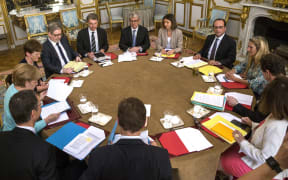 French President Francois Hollande (4thR) attends a meeting with German Chancellor (L) at the Elysee Palace in Paris.