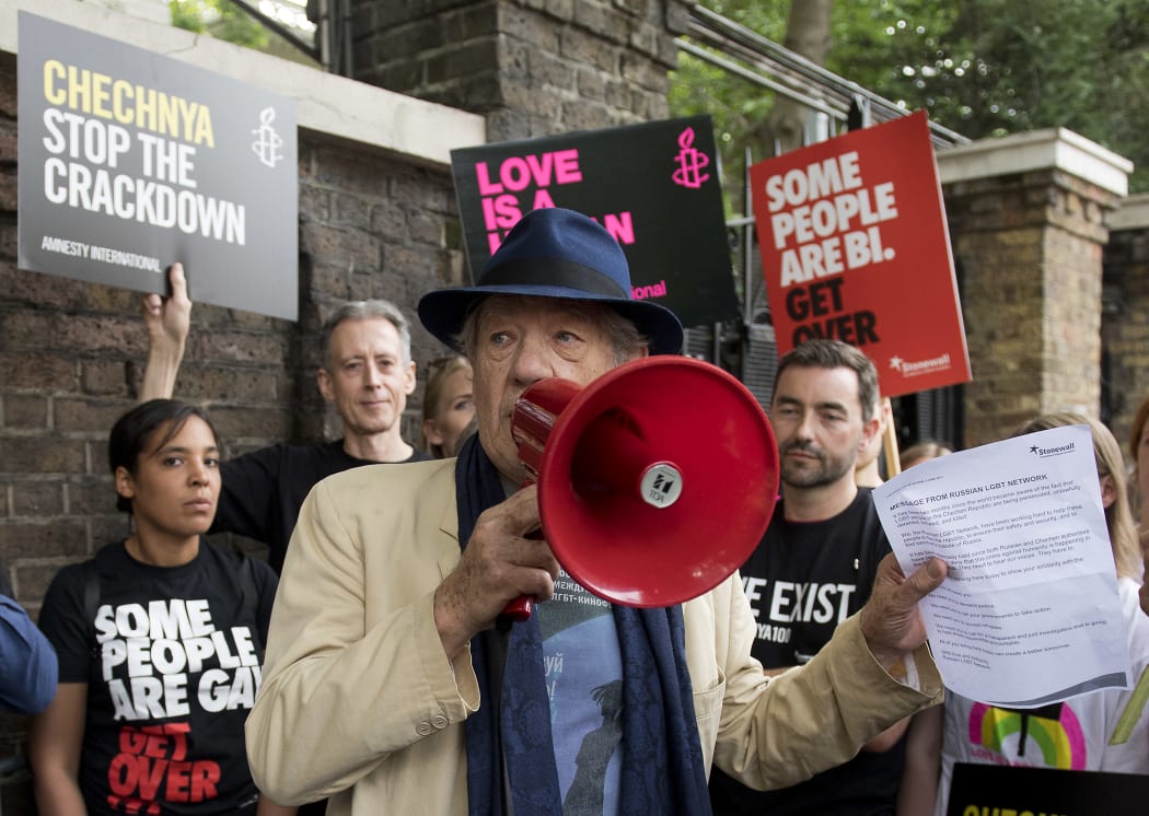 British actor Ian McKellen (C) speaks through a megaphone during a protest over an alleged crackdown on gay men in Chechnya outside the Russian Embassy in London on June 2, 2017.