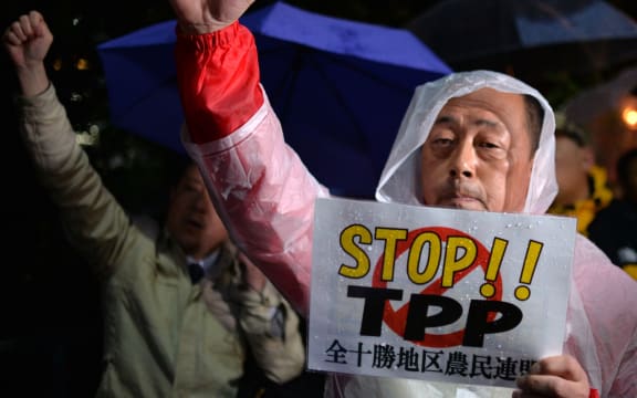 Japanese farmers porotest against the TPP trade deal at a rally the day before US President Barack Obama visits.