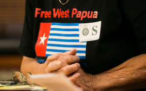Maire Leadbeater wears a "Free West Papua" shirt as she answers questions on her petition urging the government to address human rights issues in West Papua.