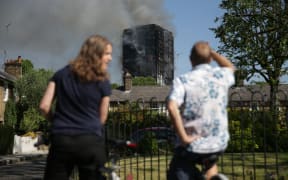 Local residents watch smoke billow from Grenfell Tower,