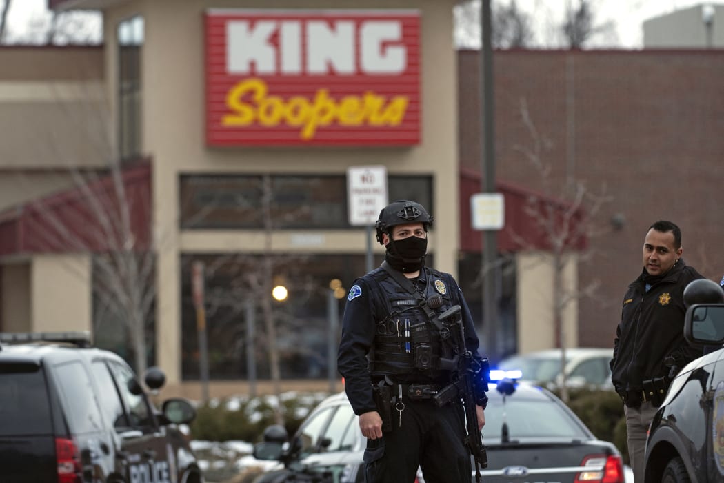 Police officers secure the perimeter of the King Soopers grocery store in Boulder, Colorado.