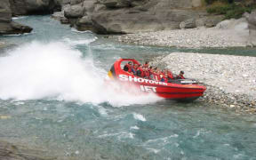 Five people were taken to hospital when the jet boat they were in hit a rock.