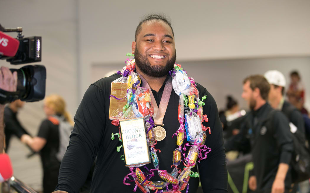 Gold medal weightlifter David Liti was greeted by family and fans in Auckland.