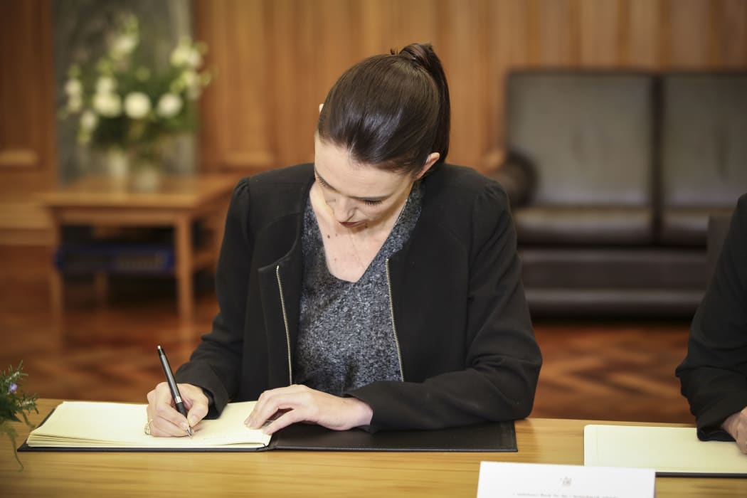 Prime Minister Jacinda Ardern signs the Condolence Book.