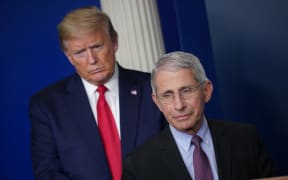 Director of the National Institute of Allergy and Infectious Diseases Anthony Fauci, flanked by US President Donald Trump, speaks during the daily briefing on the novel coronavirus, which causes COVID-19, in the Brady Briefing Room of the White House on April 22, 2020, in Washington, DC.
