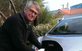 Henrik Moller plugs in his electric vehicle