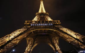The Eiffel Tower displays the message "decarbonize" within the United Nations Climate Conference on Climate Change, on 11 December 2015 in Paris.