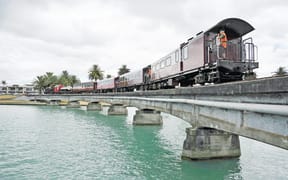 Credit: Liam Clayton/Gisborne Herald. Caption: The Wa165 crossing the Tūranganui River railway bridge in 2017. The bridge was recently found to be unsafe for the train, without “significant remedial work” being undertaken.