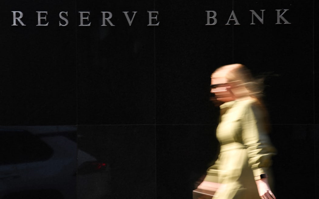 A woman walks past the Reserve Bank of Australia building in Sydney on May 3, 2022.