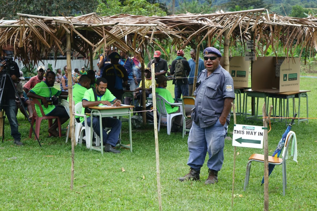 Police and electoral officials call out names of voters to come and vote, Timini, Morobe Province.