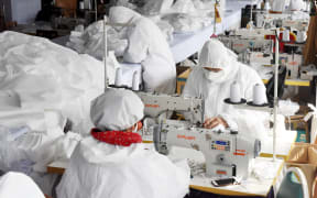 Workers make face masks at the workshop of Maliya Garments in Qingdao, east China's Shandong Province.
