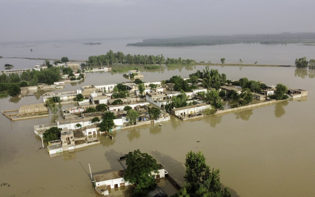 A general view of a flooded area after heavy monsoon rains is pictured from atop a bridge in Charsadda district in the Khyber Pakhtunkhwa province of Pakistan on 27 August, 2022. Heavy rain pounded much of Pakistan on 26 August after the government declared an emergency to deal with monsoon flooding it said had affected more than 30 million people.