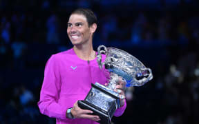 Rafael Nadal of Spain holds the Norman Brookes Challenge Cup after winning the men's singles final against Daniil Medveded of Russia at the 2022 Australian Open.