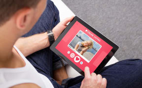 67741981 - man using online dating app on tablet