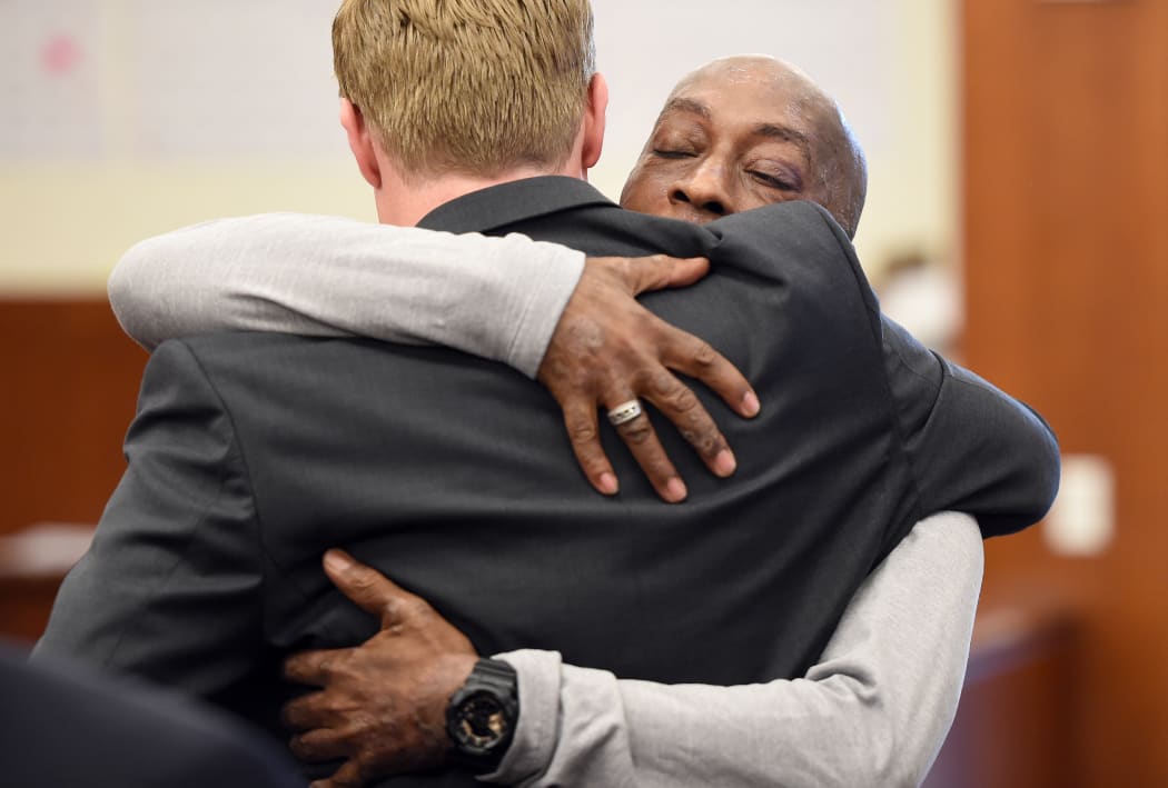 Plaintiff DeWayne Johnson hugs one of his lawyers after hearing the verdict to his case against Monsanto at the Superior Court Of California in San Francisco, California.