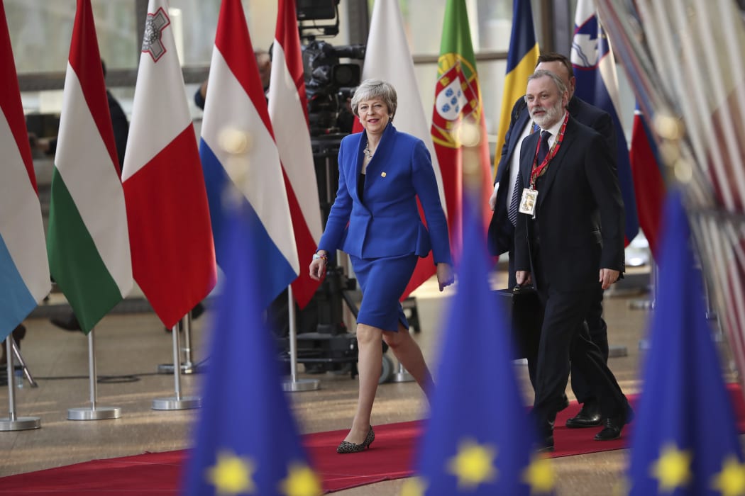British Prime Minister Theresa May, left, arrives for an EU summit at the Europa building in Brussels, Wednesday, April 10, 2019. European Union leaders meet Wednesday in Brussels for an emergency summit to discuss a new Brexit extension. (AP Photo/Francisco Seco)