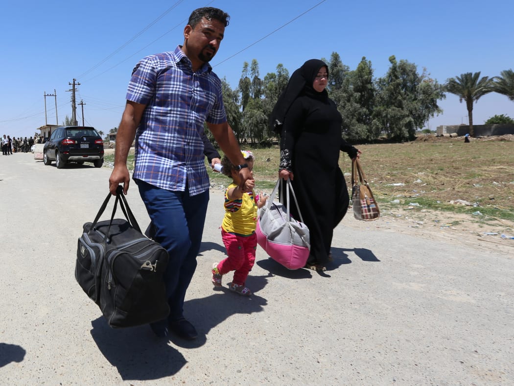 Residents from the city of Ramadi flee their homes as Islamic State tightened its siege on the city