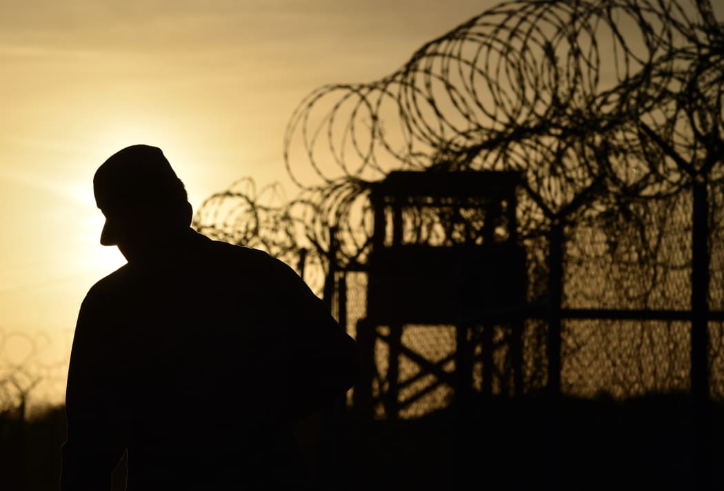 A US soldier walks next to a razor wire-topped fence at an abandoned detention facility at the US Naval Station in Guantanamo Bay (file).