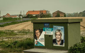 Campaign posters showing Marine Le Pen of the far-right Front National party (right) and for the far-left coalition La France Insoumise, Jean-Luc Mélenchon.