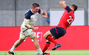 American flanker John Quill shoulder charges England playmaker Owen Farrell