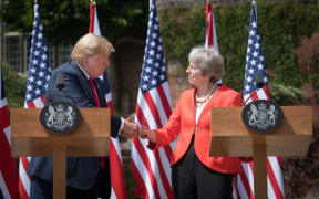 US President Donald Trump and Britain's Prime Minister Theresa May shake hands during a press conference following their meeting at Chequers, the prime minister's country residence, near Ellesborough, northwest of London on the second day of Trump's UK visit.