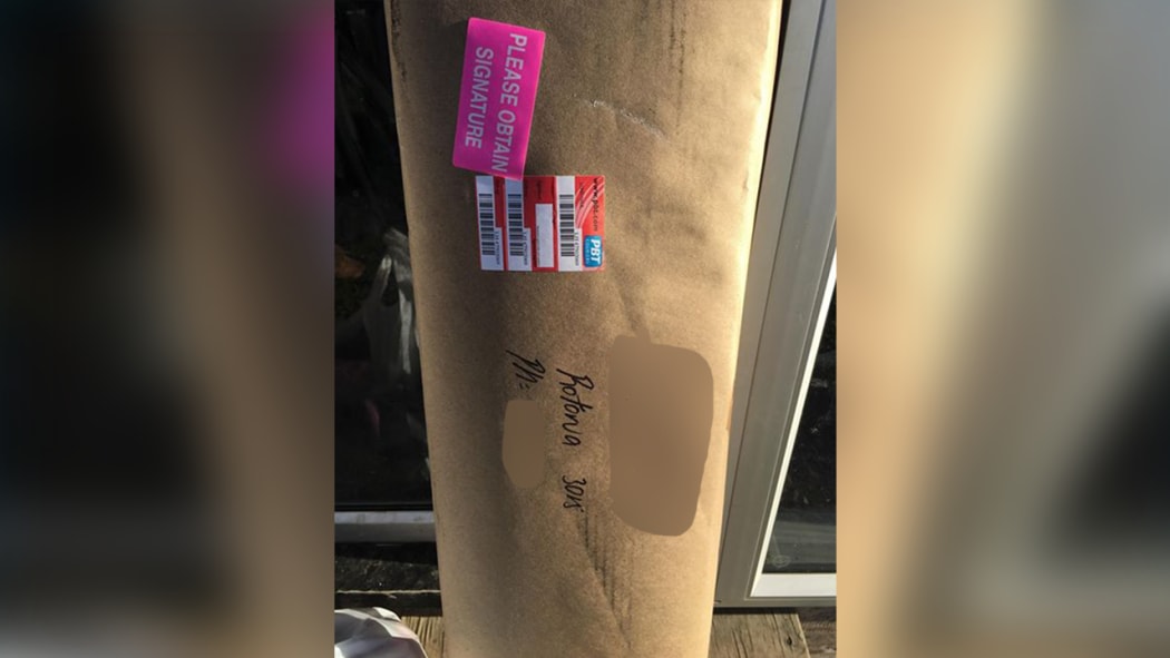 A PBT Couriers driver left this package, with a gun inside, leaning next to the front door because no one was home.
