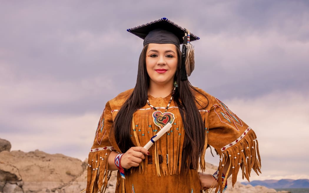 Christina Dawa Kutsmana Thomas dressed in Northern Paiute regalia, graduation photo at Pyramid Lake, Nevada
