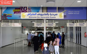 Travellers arrive at the Mitiga International Airport after its reopening on September 7, 2018, in the Libyan capital of Tripoli.