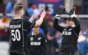 New Zealand's James Neesham (L) celebrates after taking the final wicket of India's Yuzvendra Chahal and winning the 2019 Cricket World Cup first semi-final between New Zealand and India at Old Trafford in Manchester, northwest England, on July 10, 2019.