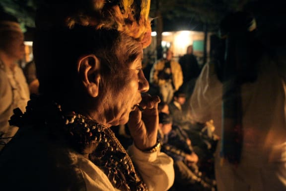 A man smokes 'sacred tobacco' at the start of an ayahuasca ritual ceremony, in Ecuador.