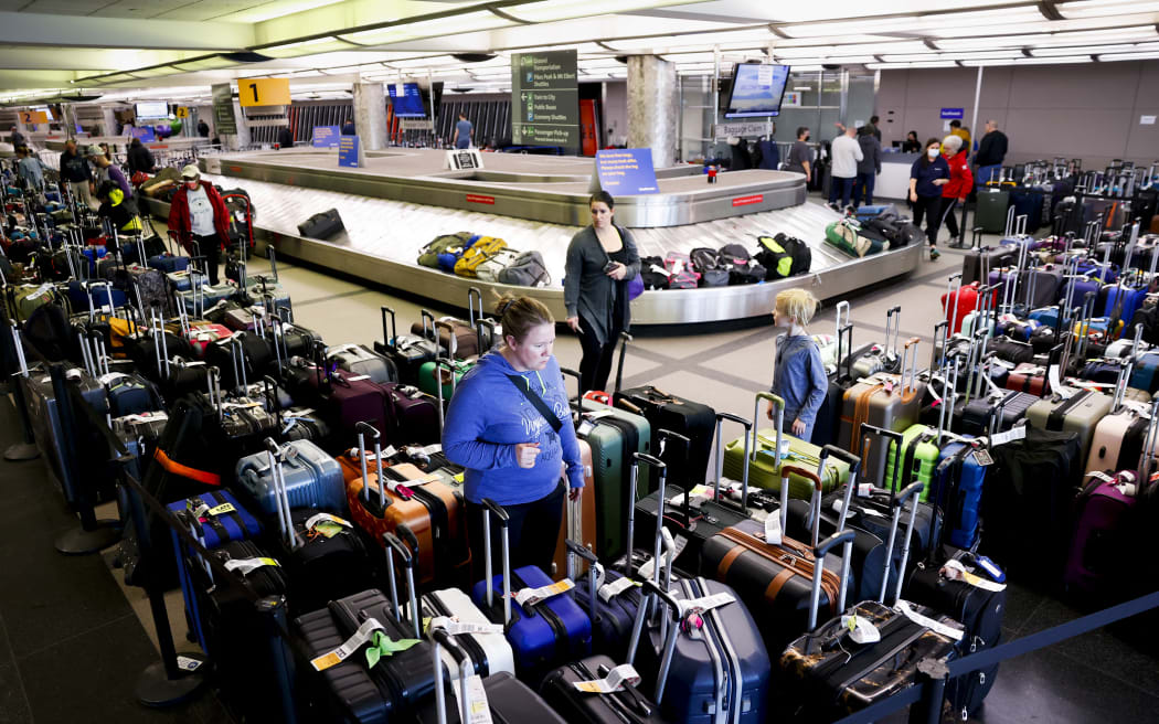 Travellers search for their suitcases in a baggage holding area for Southwest Airlines at Denver International Airport on December 28, 2022 in Denver, Colorado.