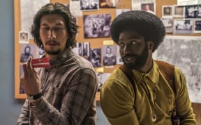 This image released by Focus Features shows Adam Driver, left, and John David Washington in a scene from "BlacKkKlansman."