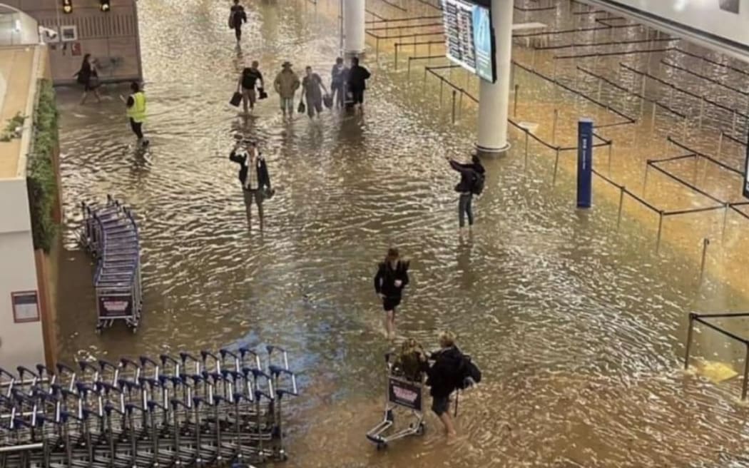 A terminal at Auckland International Airport is flooded.