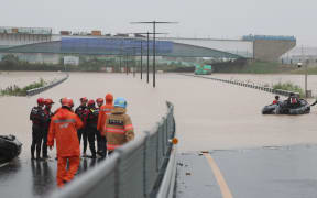 Rescuers battle to reach cars in flooded tunnel, 26 dead in South Korea floods