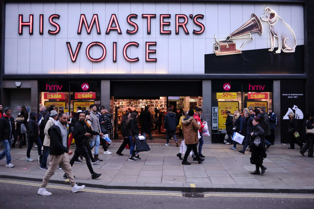 Sales shoppers pass a branch of troubled retailer HMV on Oxford Street in London, England, on December 28, 2018.
