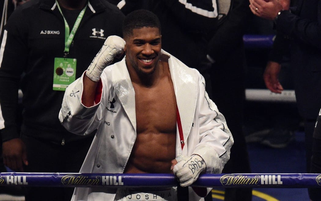 Anthony Joshua of Great Britain celebrates victory over Joseph Parker following their heavyweight unification bout at Principality Stadium in Cardiff, March 31, 2018.