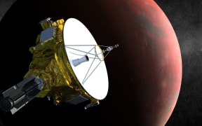 An artist's concept of the New Horizons spacecraft as it approaches Pluto and its three moons.