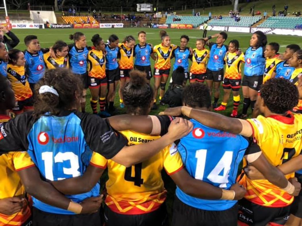 The Fiji Bulikula and the PNG Orchids huddle after their first ever meeting which Fiji won 28-0