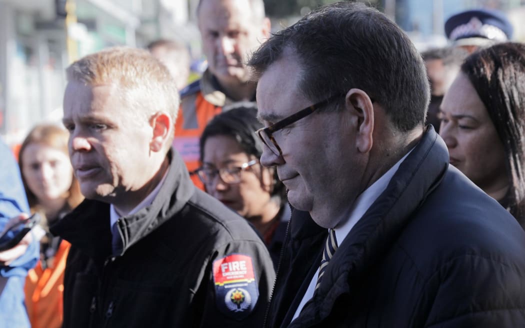 Prime Minister Chris Hipkins, Wellington Central MP and Finance Minister Grant Robertson and Wellington mayor Tory Whanau at the scene of the fire at Loafers Lodge hostel, Newtown.