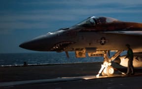A US F/A-18E Super Hornet - shown on the flight deck of an aircraft carrier supporting strikes in Iraq and Syria.