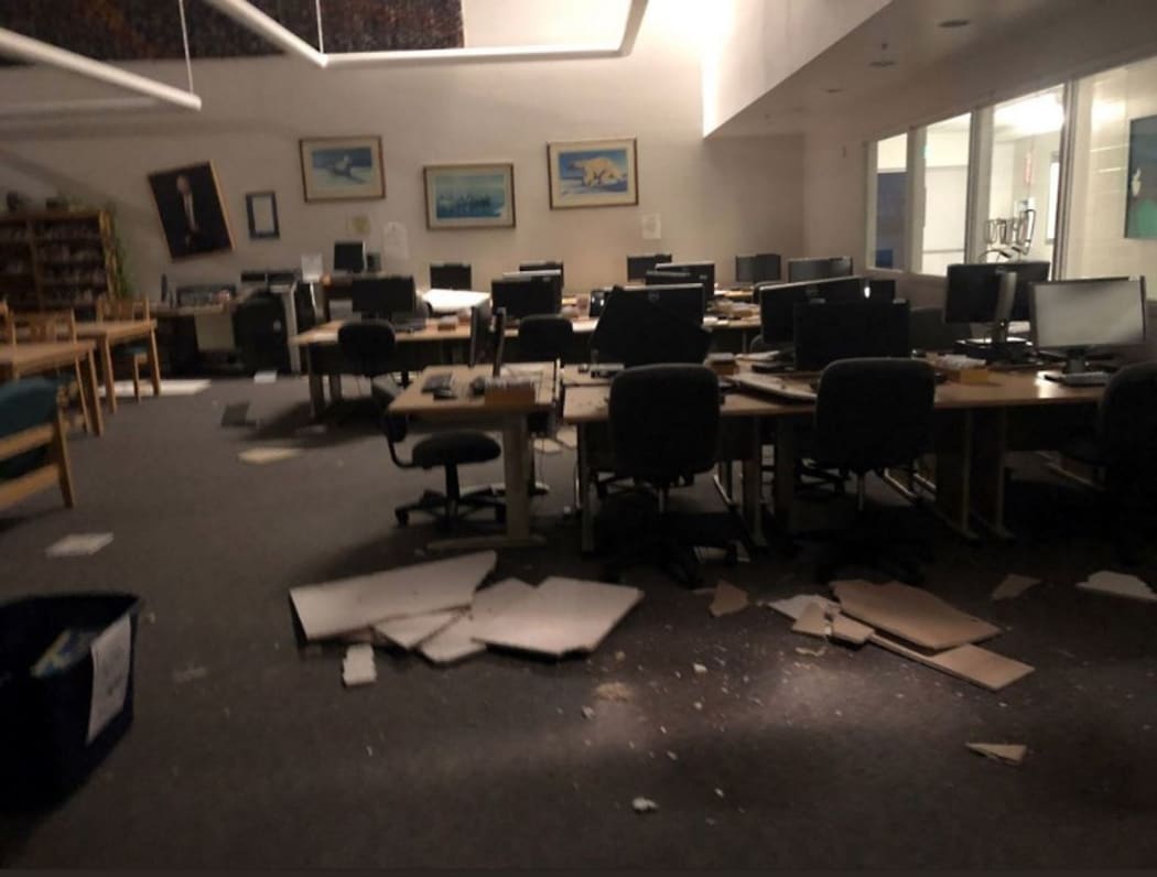Books and ceiling tiles litter the floor at theThe Mat-Su College library in Anchorage, Alaska, on November 30, 2018, after a 7.0 magnitude earthquake.