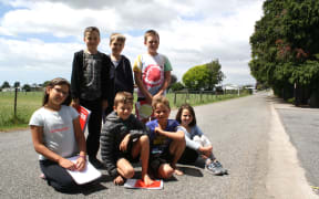 Tua Marina School students, from left, on bottom, Peyton Couper, Frank Brought, Quinn Verran, Jasmine Tierney, and above, Ethan Abbott, Henry Nott and Lucas Collins, asked the Marlborough District Council to reduce the 100kmh zone at their school.