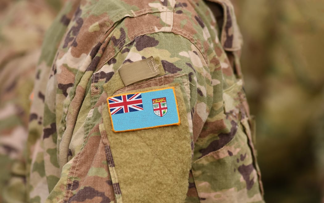 Flag of Fiji on soldiers arm. Flag of Fiji on military uniforms (collage).