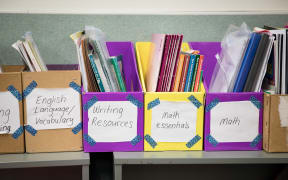 Primary school learning resources on a classroom shelf. Includes Math and Vocabulary as well as other resources.