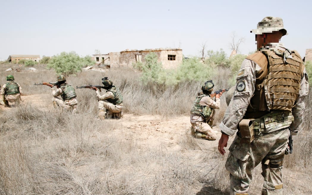 A New Zealand Defence Force trainer instructs ISF soldiers in correct weapons firing positions. Iraq 2015