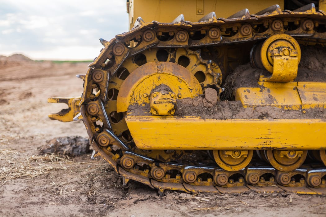 Yellow Tractor on caterpillar tracks, tractor tracks