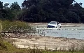 A 4WD being washed in Lake Waiporohita.
